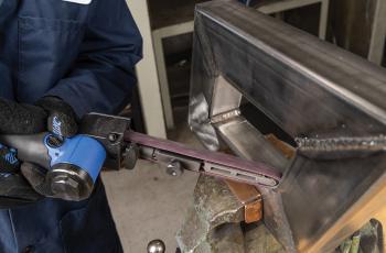 Operator using a Norton Vortex Rapid Prep file belt