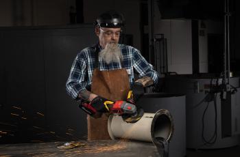 Operator using a Norton Quantum3 depressed center wheel on an angle grinder