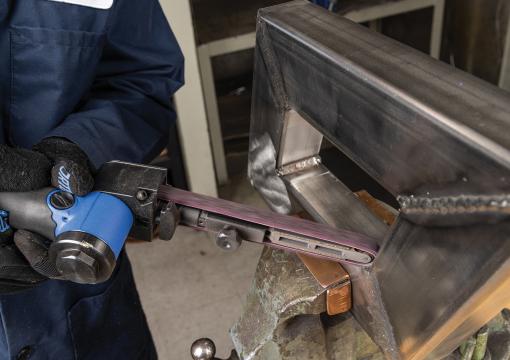 Operator using a Norton Vortex Rapid Prep file belt