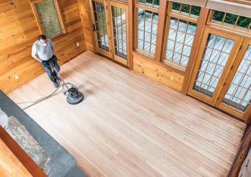 Man using a floor buffing machine on wood floors