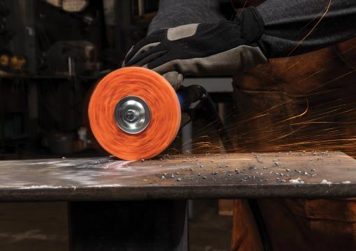 Operator using a Norton Blaze RapidStrip non-woven disc