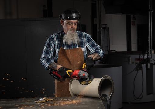 Operator using a Norton Quantum3 depressed center wheel on an angle grinder
