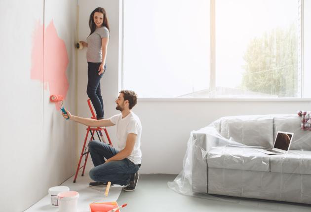 Man and woman preparing to decorate room