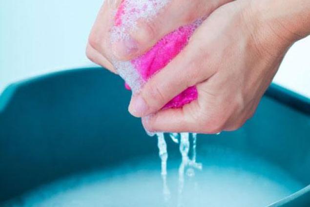 Hands squeezing a cloth