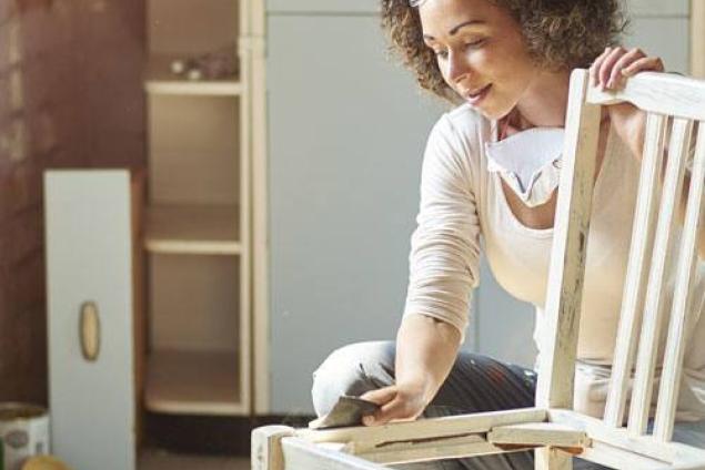 Woman sanding a chair