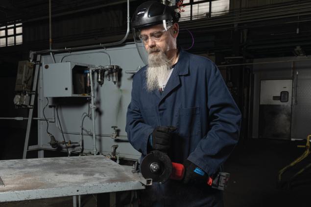 Operator using Norton thin wheels to cut an aluminum workpiece