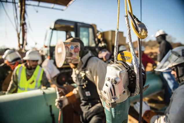 Image of welder working on a pipeline