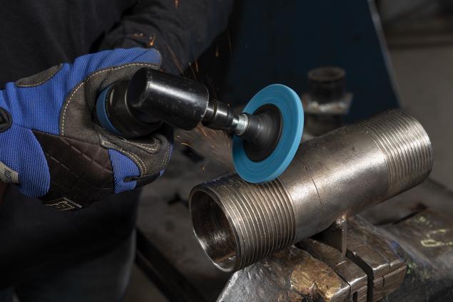 Operator using a Norton Vortex Rapid Blend quick-change disc