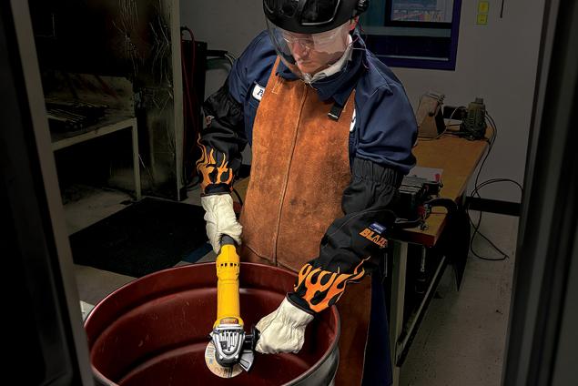 Operator performing a barrel test using a Norton Quantum3 depressed center wheel on an angle grinder