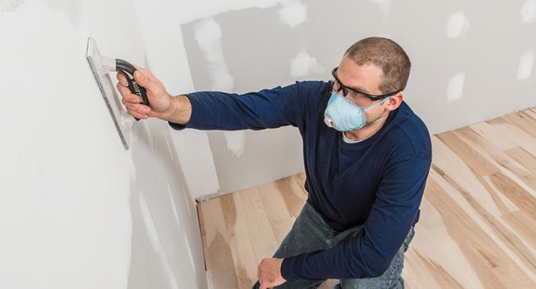Man sanding a drywall