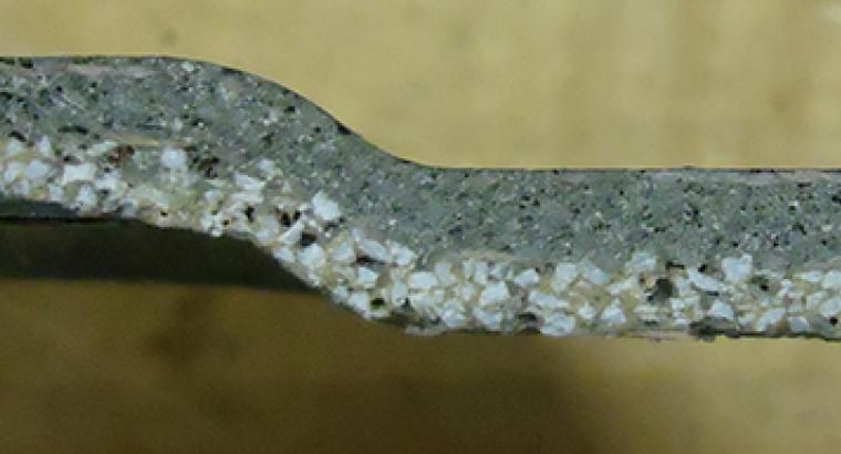 Figure 6. An example of the standard orientation of fiberglass reinforcing layers in depressed center grinding wheels that is required by ANSI B7.1 safety standards when using portable handheld power tools.