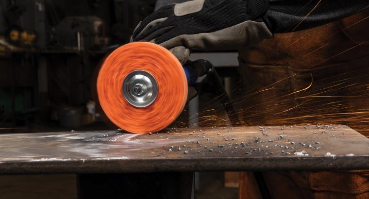 Operator using a Norton Blaze RapidStrip non-woven disc