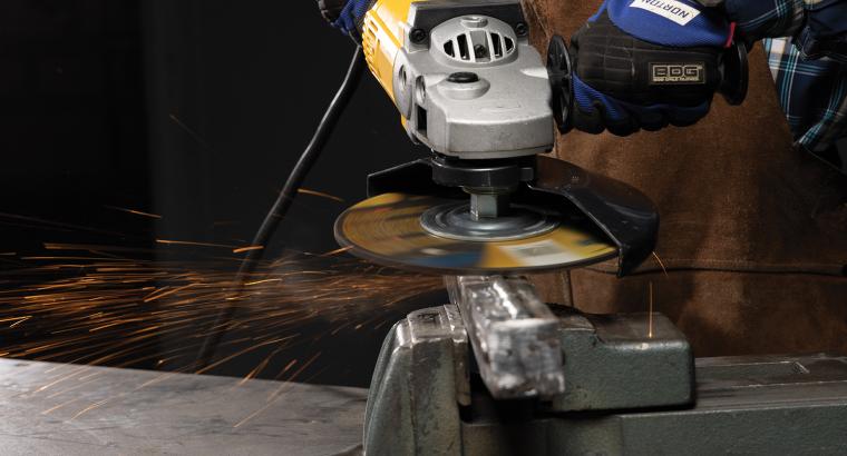 Close up of an operator using a 9" Norton Quantum3 depressed center wheel