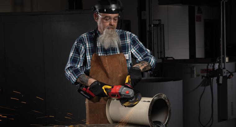 Operator using a Norton Quantum3 depressed center wheel on an angle grinder