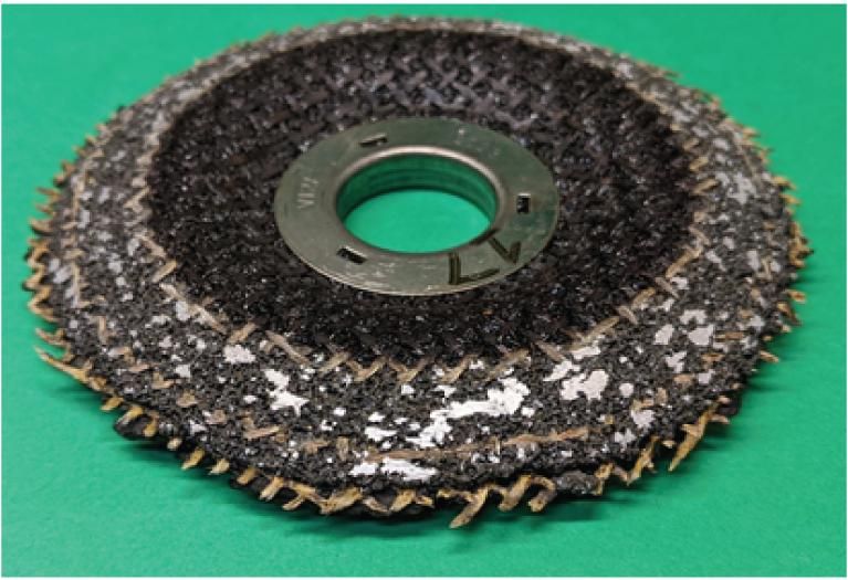 Competitor grinding wheel shows more loading than the Norton wheel.